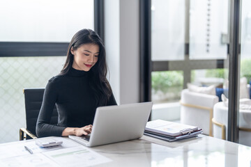 Beautiful confident asian business woman working with laptop Hands typing  keyboard. Professional investor working new start up project. business planning in office. Technology business