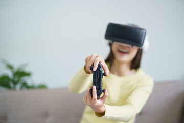 Young Asian woman wearing virtual reality touching air during the VR experience  Future technology...