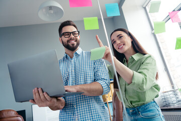 Photo of two people student hold use netbook working on educational project in workspace