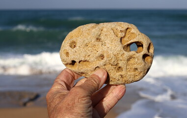 A person's hand holds objects close-up.