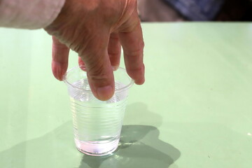 A person's hand holds objects close-up.