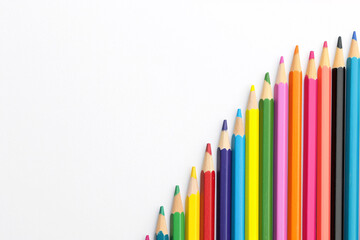 Fototapeta premium Curved arrangement of colorful pencils on a white background displaying a wide range of colors ideal for artistic projects, school use, and creative activities