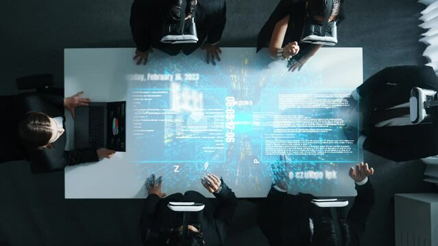 Skilled project manager working on laptop and sending data analysis to business people by using VR glass with hologram of financial coding program or holographic software development. Directorate.