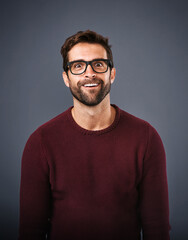 Obraz premium Studio, glasses and man with funny face, portrait and wellness with eye care, product or lens for vision. Gray background, silly or happiness for person, prescription and eyewear with fashion in USA