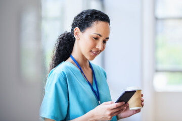 Medical Professional Checking Phone During Break in Hospital