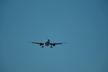 Airplane landing at the airport on a sunny day