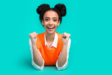 Photo of nice young girl raise fists empty space wear vest isolated on teal color background