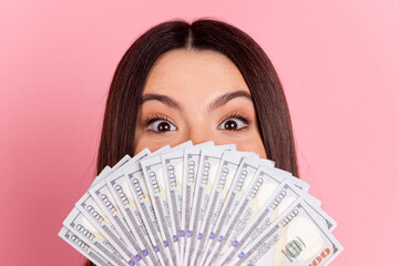 Photo of charming positive girl rising money fan close mouth isolated pink color background
