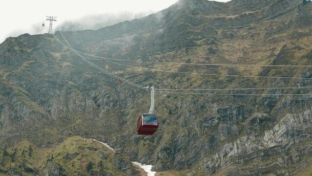 Red gondola cable car riding in Swiss Alps, mount Pilatus near Lake Lucerne