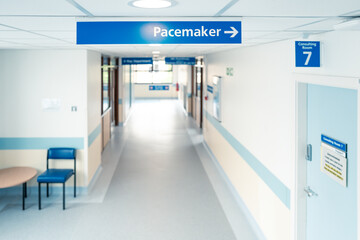 Shallow focus of a Pacemaker sign inside a typical UK public hospital. The sign leads to a room to check a fitted heart pacemaker in a patient, post op.
