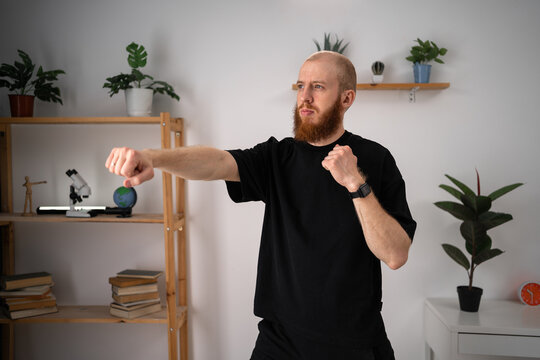 Athletic Healthy man workout boxing exercise training at home. Young male punching boxing footwork cardio - Powered by Adobe