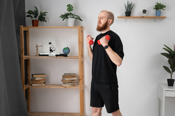 Fitness, sport, weightlifting concept. Caucasian bearded man exercising with dumbbells at home