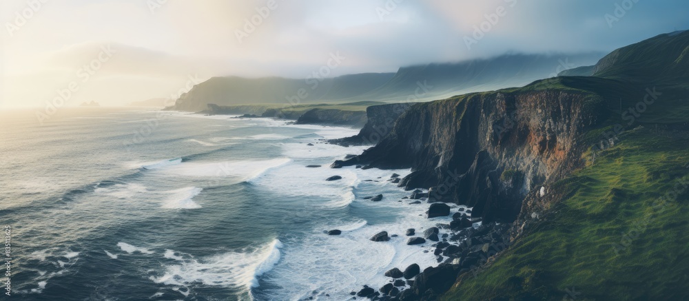 Poster Coastal cliffs by the ocean during the evening create a stunning backdrop for a copy space image.