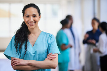Confident Female Nurse Smiling in a Multi-Ethnic Medical Team Setting