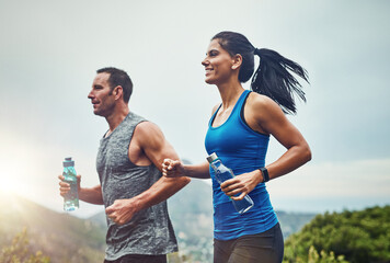 Energy, running and couple for outdoor exercise with water bottle, fitness adventure and training...