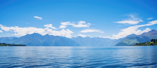 Scenic view of a lake, mountains, and clear blue sky with copy space image.