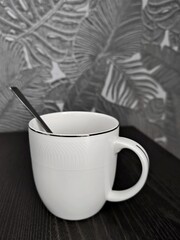 Empty white cup with metal spoon