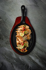 frying pan with grilled chicken