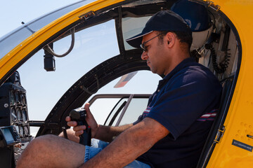 helicopter Arab pilot, flying a rescue chopper, wearing helmet and headset