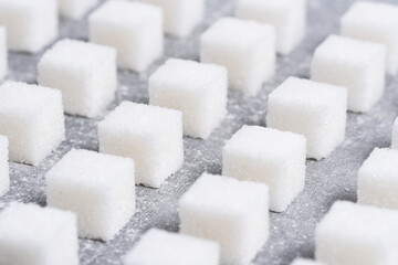 Refined sugar cubes are laid out in clear geometric lines.
