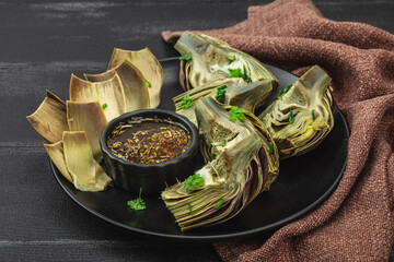 Traditional italian artichoke «alla romana», cooked carciofi vegetable. Olive oil, garlic, parsley