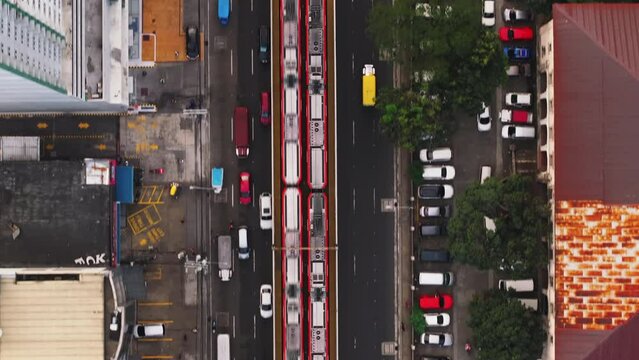 Aerial view of Manila streets and fast elevated trains arriving to the station. Urban and city transportation concepts