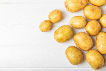 Young potatoes. Fresh potatoes  on a wooden background.Harvesting collection. organic, freshly dug...