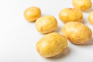 Young potatoes. Fresh potatoes  on a wooden background.Harvesting collection. organic, freshly dug potatoes. Agricultural background. Vegan. Vegetables.Place for text.Copy space