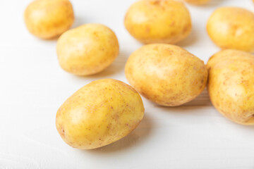 Young potatoes. Fresh potatoes  on a wooden background.Harvesting collection. organic, freshly dug potatoes. Agricultural background. Vegan. Vegetables.Place for text.Copy space