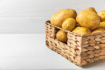 Young potatoes. Fresh potatoes  in wooden crate on a wooden background.Harvesting collection....