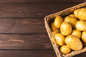 Young potatoes. Fresh potatoes  in wooden crate on a wooden background.Harvesting collection....