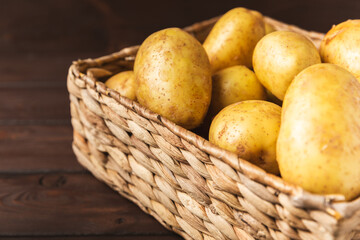 Young potatoes. Fresh potatoes  in wooden crate on a wooden background.Harvesting collection....