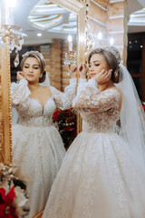 Naklejka premium A woman is getting ready for her wedding, putting on her wedding dress and checking herself in the mirror