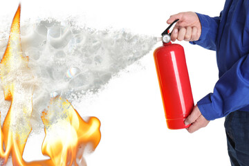 Man using fire extinguisher against flame on white background, closeup