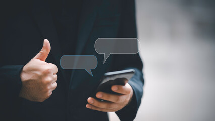 Social media marketing technology concept.Man hand using smartphone typing Live chat chatting and social network concepts, chatting conversation working at home in chat box icons pop up.