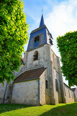 Fototapeta premium Church of Saint Germain in Nargis, a village of the French department of Loiret, Centre Val de Loire, France - Built in the 15th century it has a bell tower in a Dauphinois style