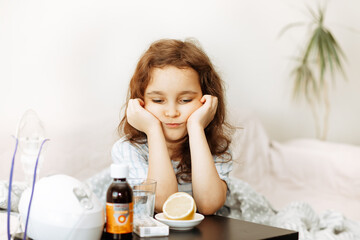 Sick sad little kid girl sits on bed at home. Asthma medicine. Flu season. Healthcare concept.