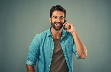 Portrait, man and fashion on phone call with style, cheerful on mobile in gray background. Male...