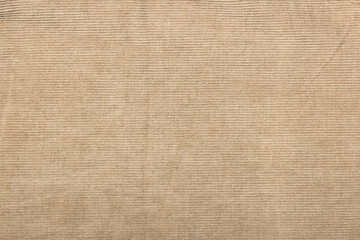 beige corduroy fabric background. slightly worn