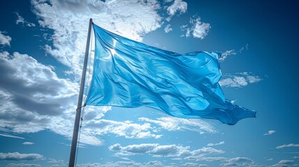 a blue flag flying in the wind on a sunny day