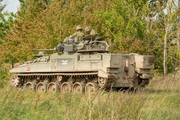 Obraz premium close-up of Captain and gunner directing action in a British army Warrior FV510 IFV tank on military manoeuvres, Wilts UK