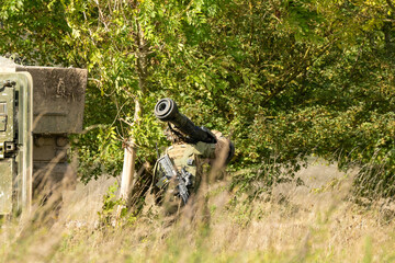 Close-up of a British army Infantry soldier with a Saab Bofors Dynamics NLAW (MBT LAW or RB 57) anti-tank missile, moving into woodland