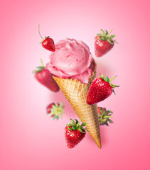 Composition levitation Strawberry ice cream waffle cone with Strawberries on pink background. In the air, vertical food photo banner