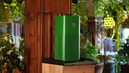 Portable device for cleaning air operating in indoor plant-filled coffee shop during daytime