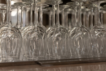 set of upside down wine glasses at a bar counter