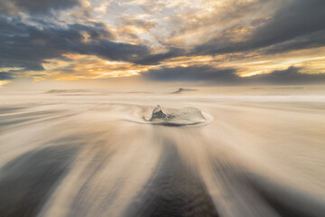 astract-shaped block of ice formed by water with trails from the holas © algaru57