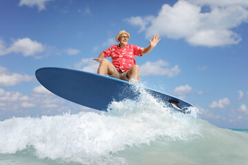 Mature male tourist on top of a surfing board