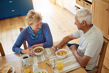 Elderly, couple or happy with eating at breakfast in dining room for nutrition, healthy meal or...