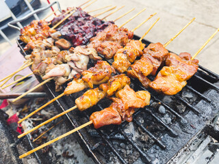 Chicken meat fried on the grill on wooden skewers