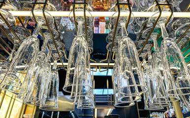 Glass glasses of champagne hang above the bar